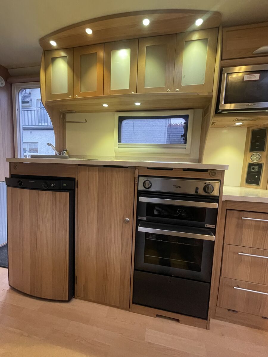 Kitchen with oven, hob, microwave and fridge